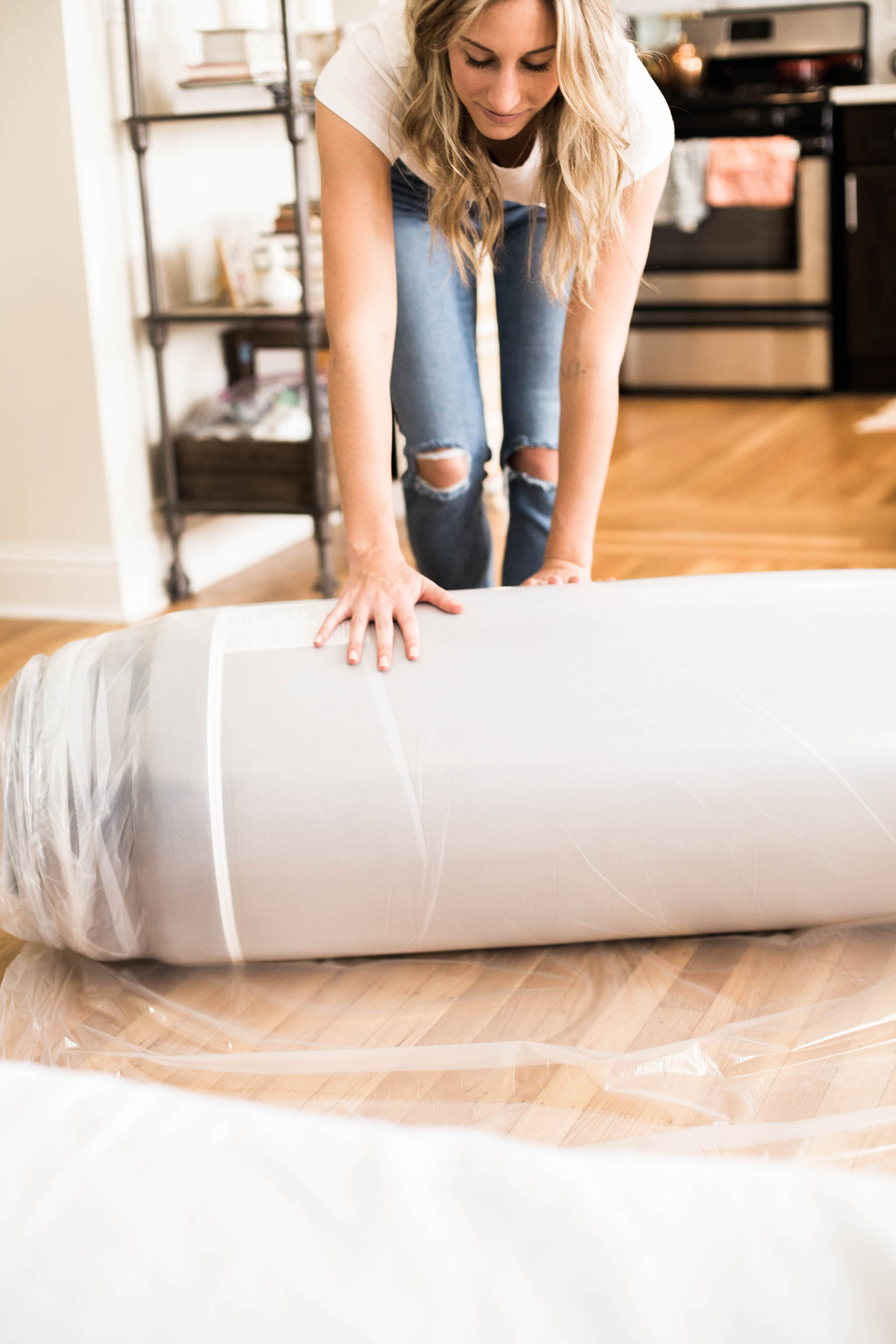 Amanda Holstein opening Cocoon by Sealy mattress delivery box