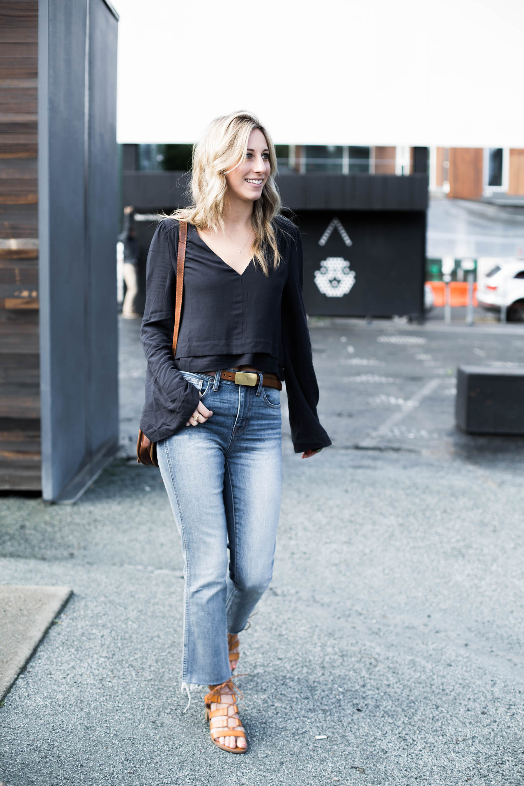 Amanda Holstein in spring outfit of Free People top, Madewell jeans, Old Navy sandals