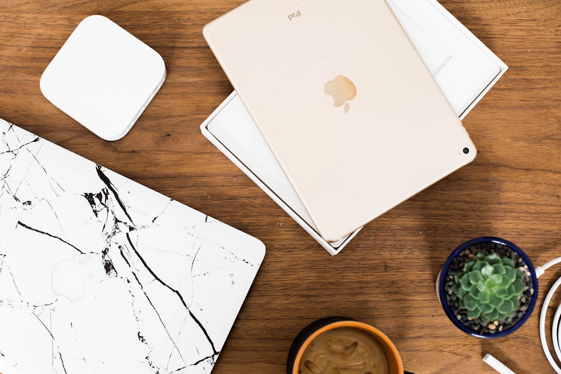 Apple products on coffee table, Airport, iPad and Macbook Pro with marble cover