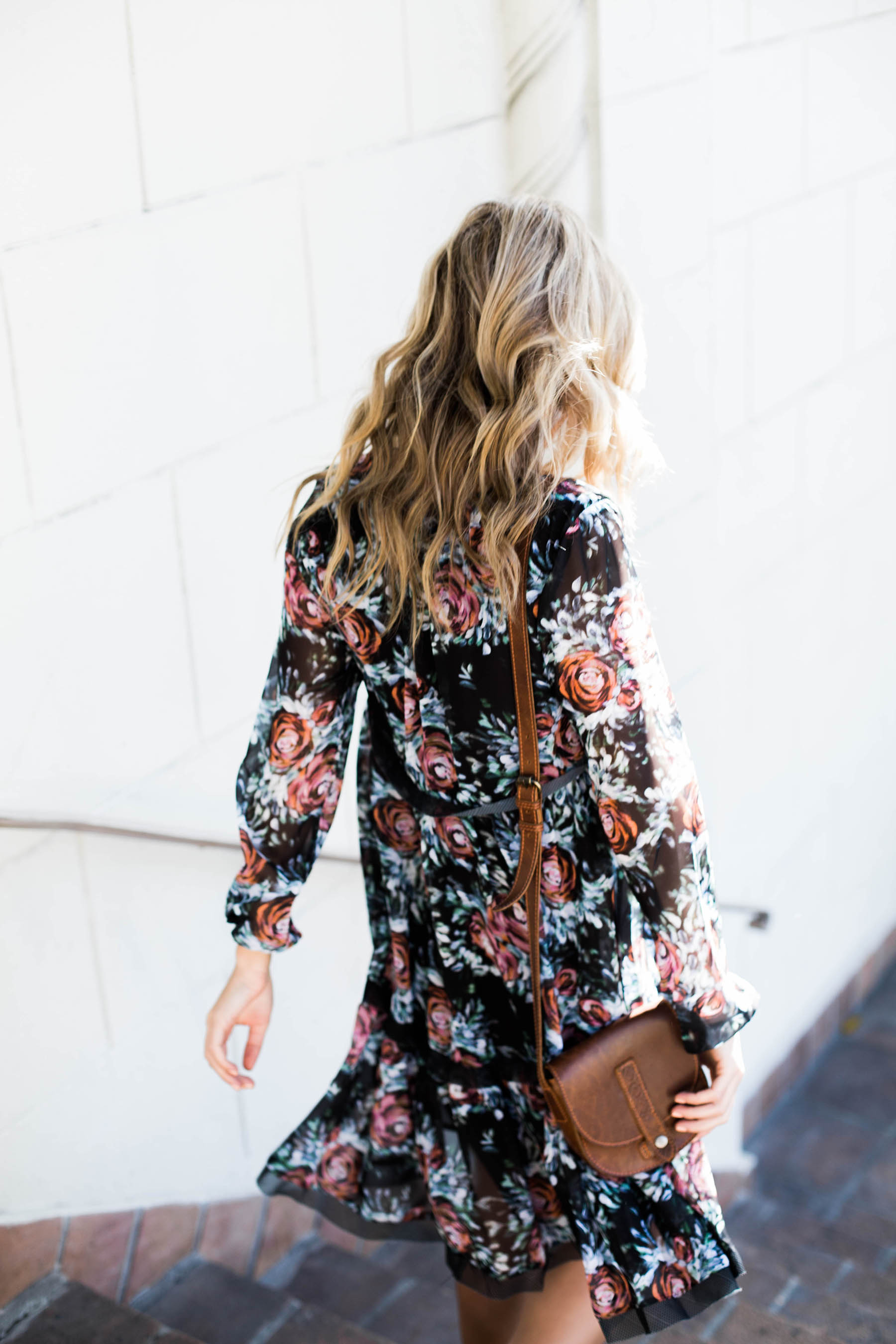 Amanda Holstein in anthropologie floral swing dress and Urban Outfitters crossbody bag