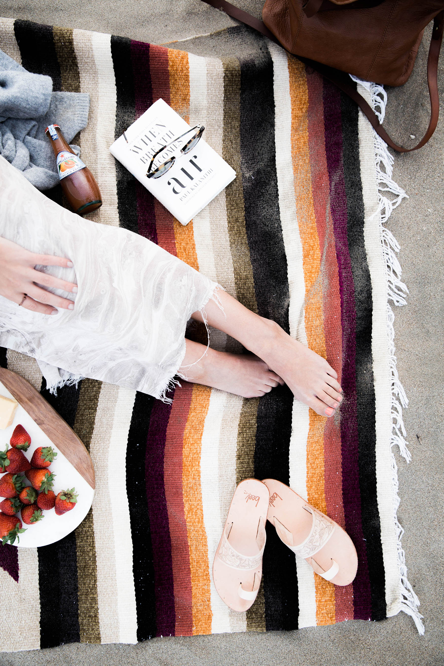 beach picnic with mexican blanket and beek sandals