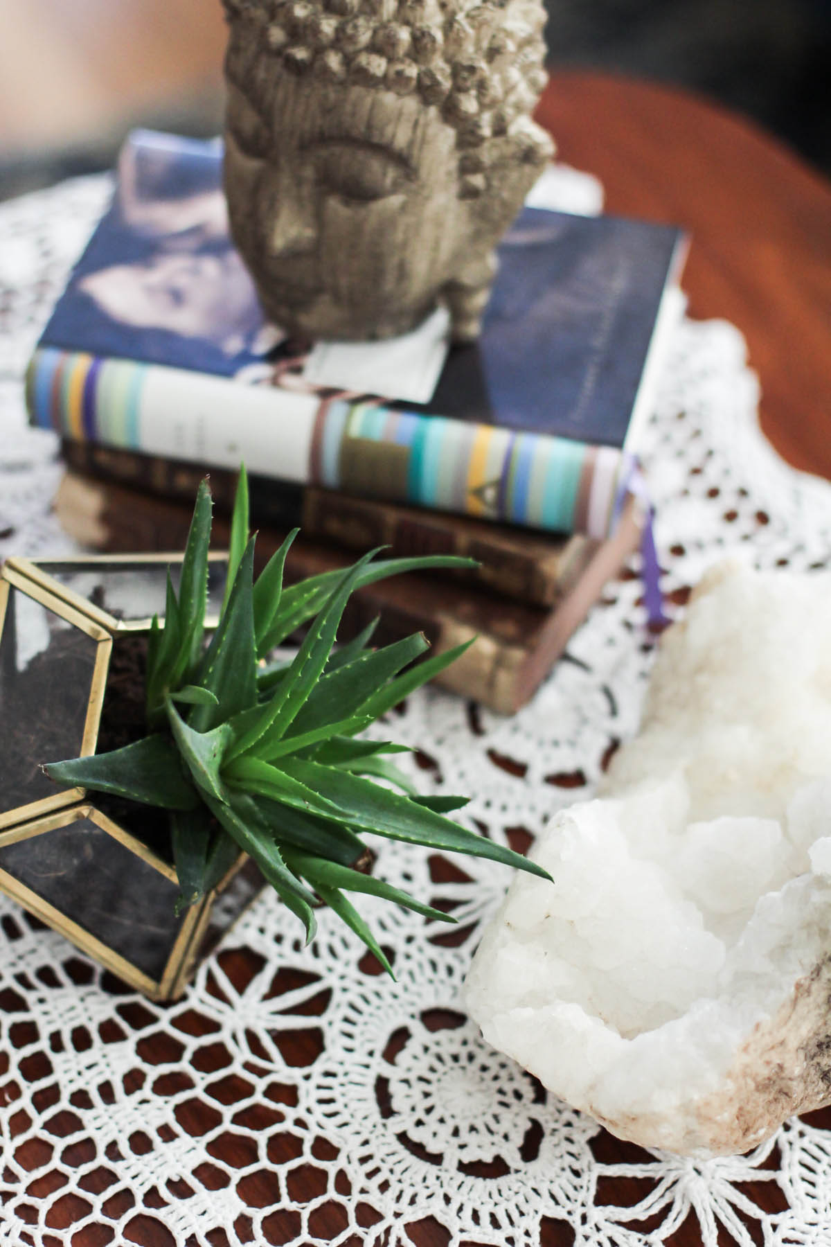 boho coffee table decor with succulent terrarium, geode, and buddha