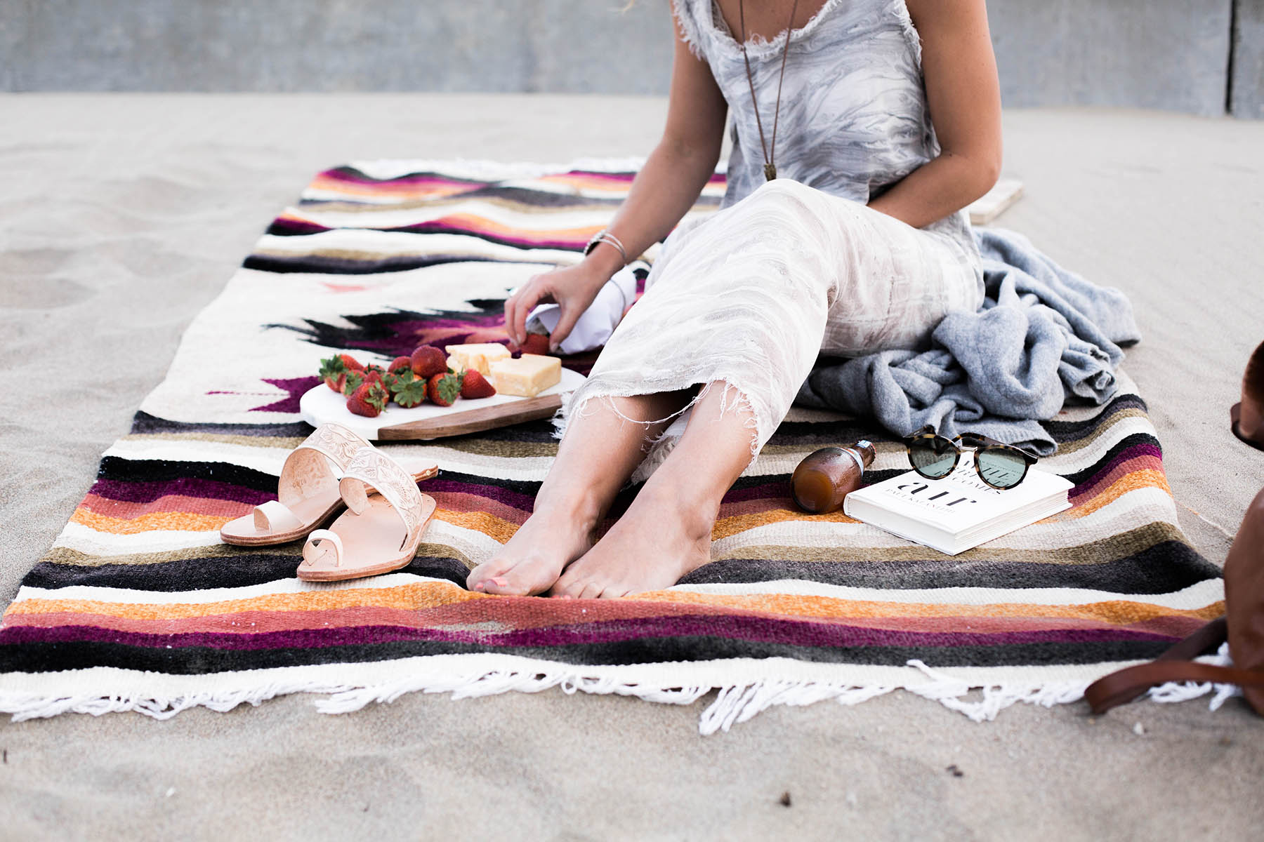 beach picnic with mexican blanket and beek sandals