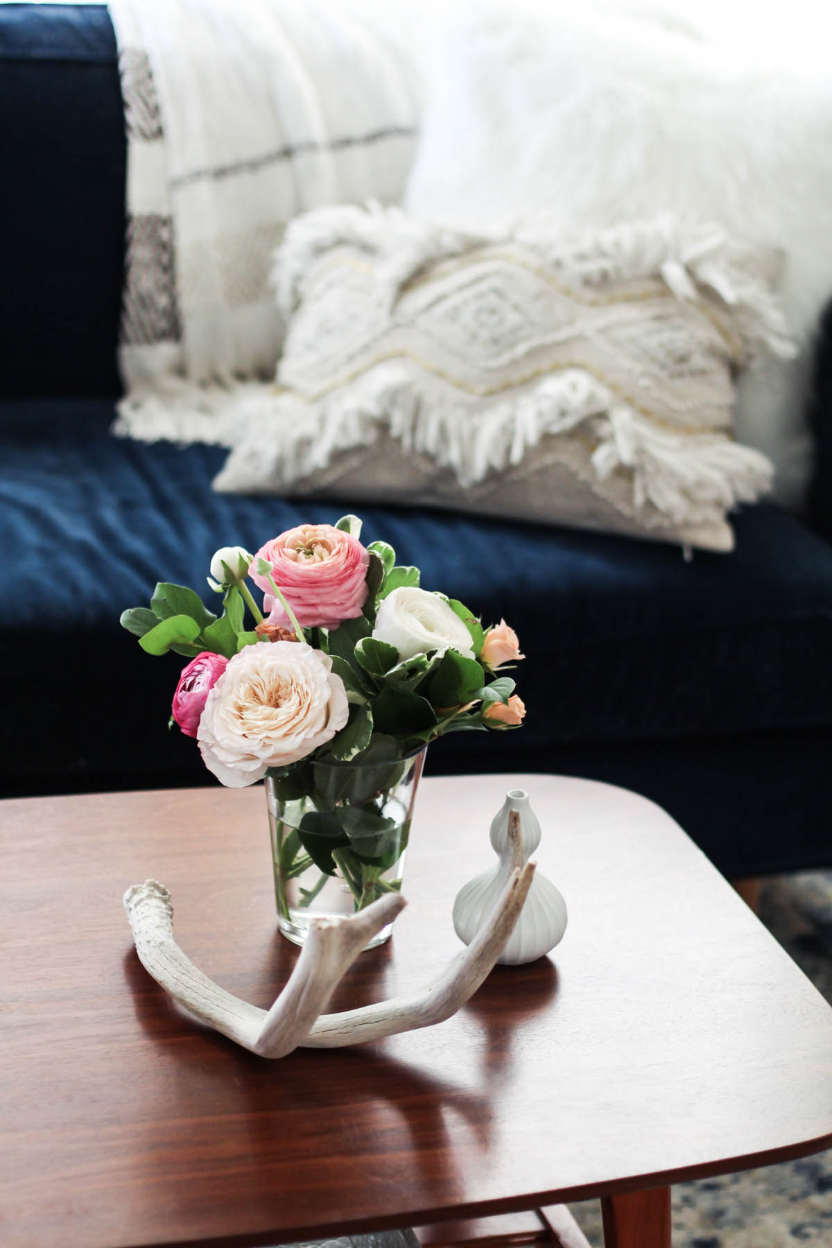 feminine coffee table styling with flowers and antlers