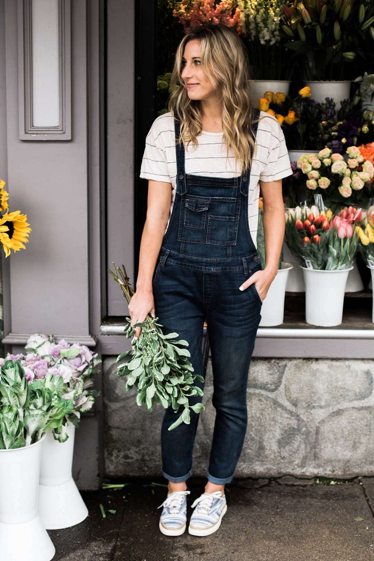 Free People denim overalls, Madewell striped tee, and wavy blonde hair
