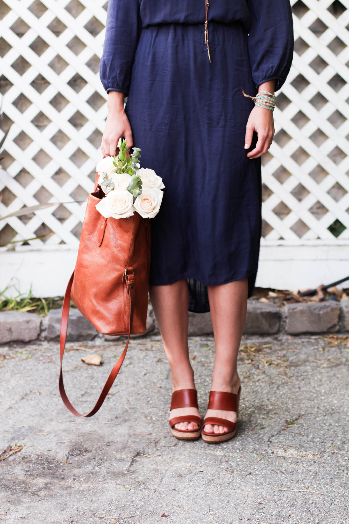 Amanda Holstein in spring outfit navy dress and leather sandals