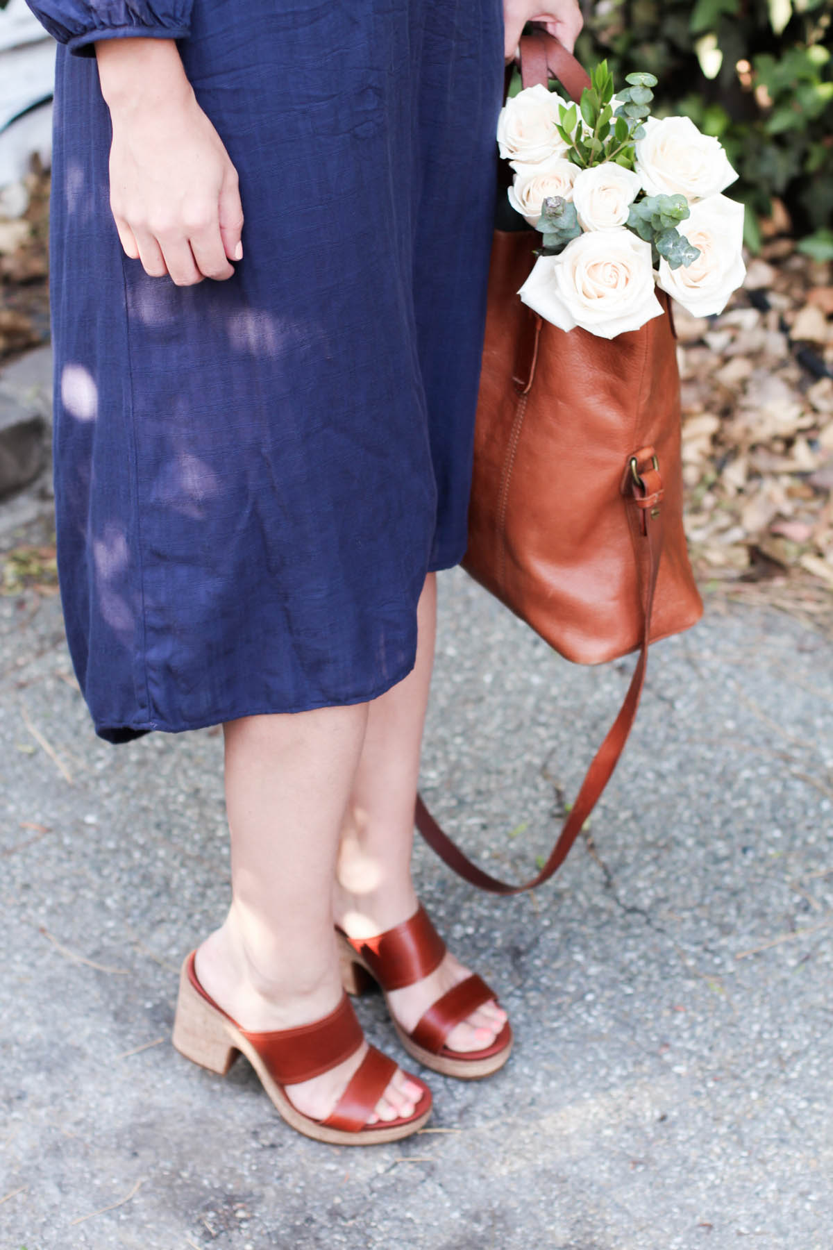 Amanda Holstein in spring outfit navy dress and leather sandals