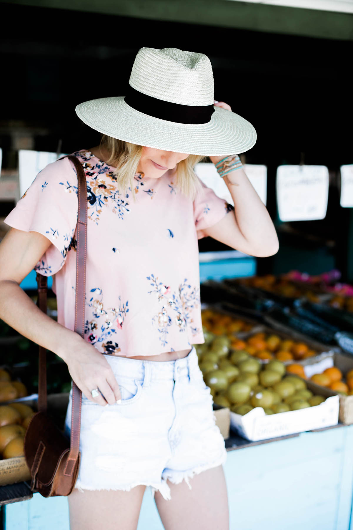 Amanda Holstein in Urban Outfitters crop top, panama hat, and denim shorts