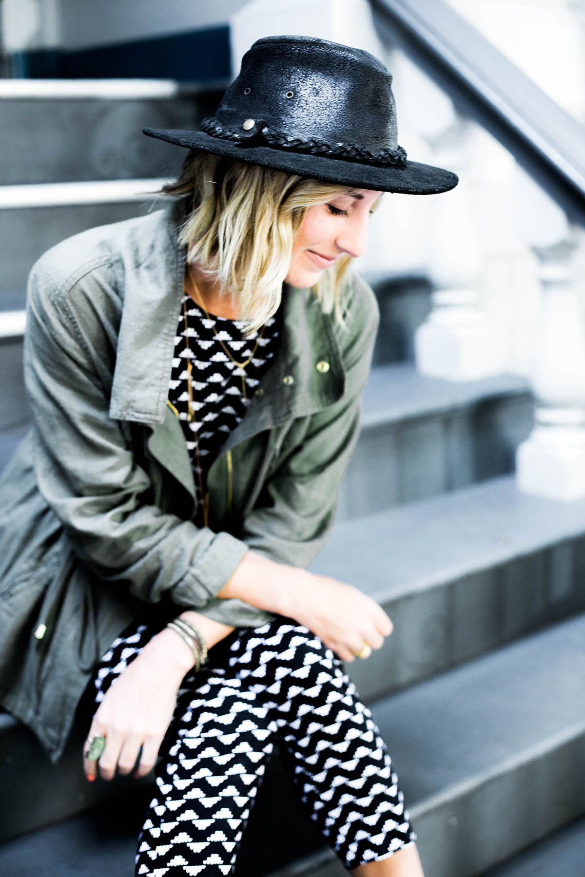 Amanda Holstein in Old Navy printed jumpsuit outfit, utility jacket and free people hat