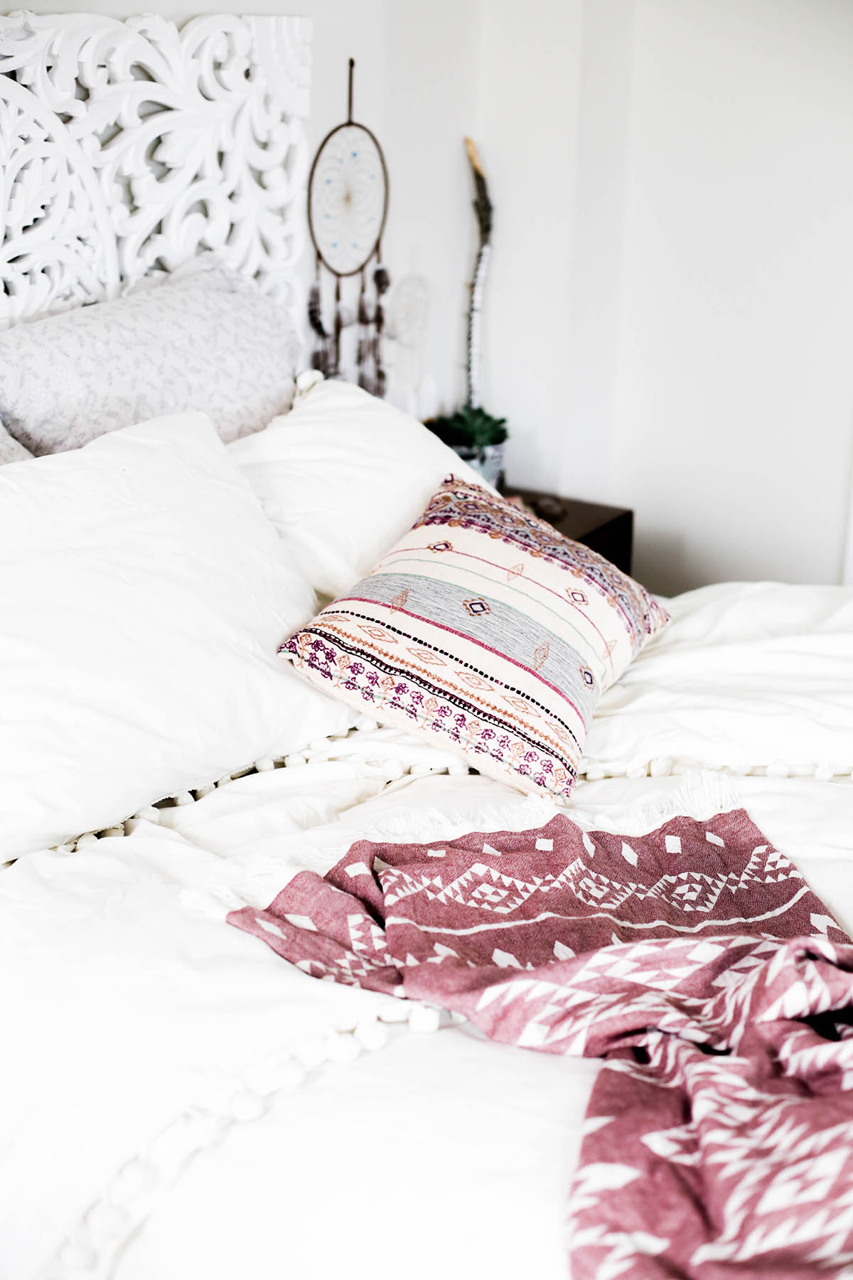 Urban Outfitters bedroom with Magical Thinking Pom-Fringe Duvet Cover and Agda Printed Yarn Pillow and Sienna Headboard