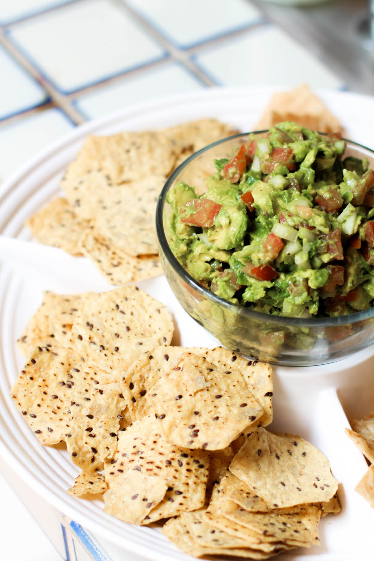 chunky guacamole on serving platter with chips