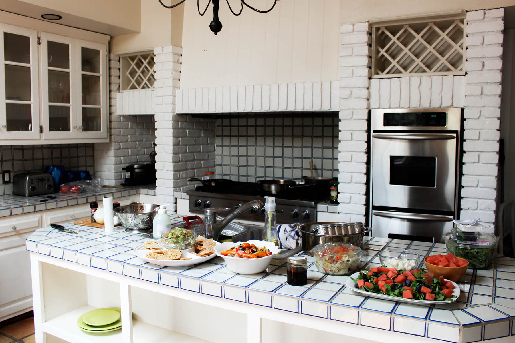 all white rustic kitchen with colorful food for family dinner