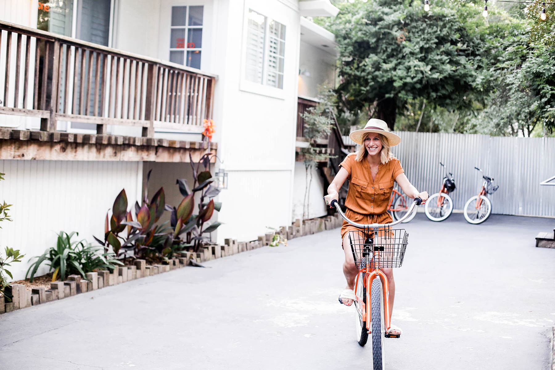 Amanda Holstein riding banks in Old Navy romper and woven fedora hat