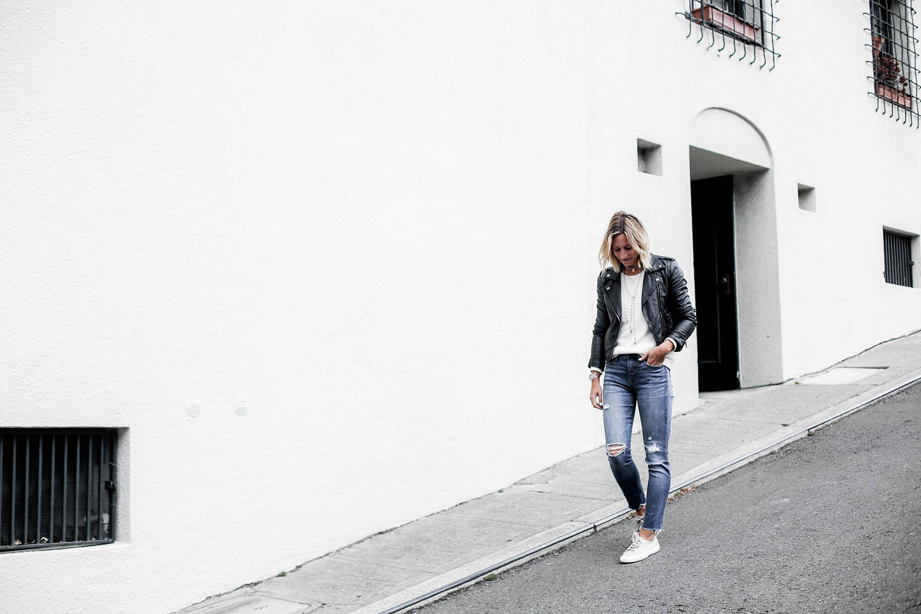 black leather moto jacket with madewell distressed skinny jeans and superga sneakers