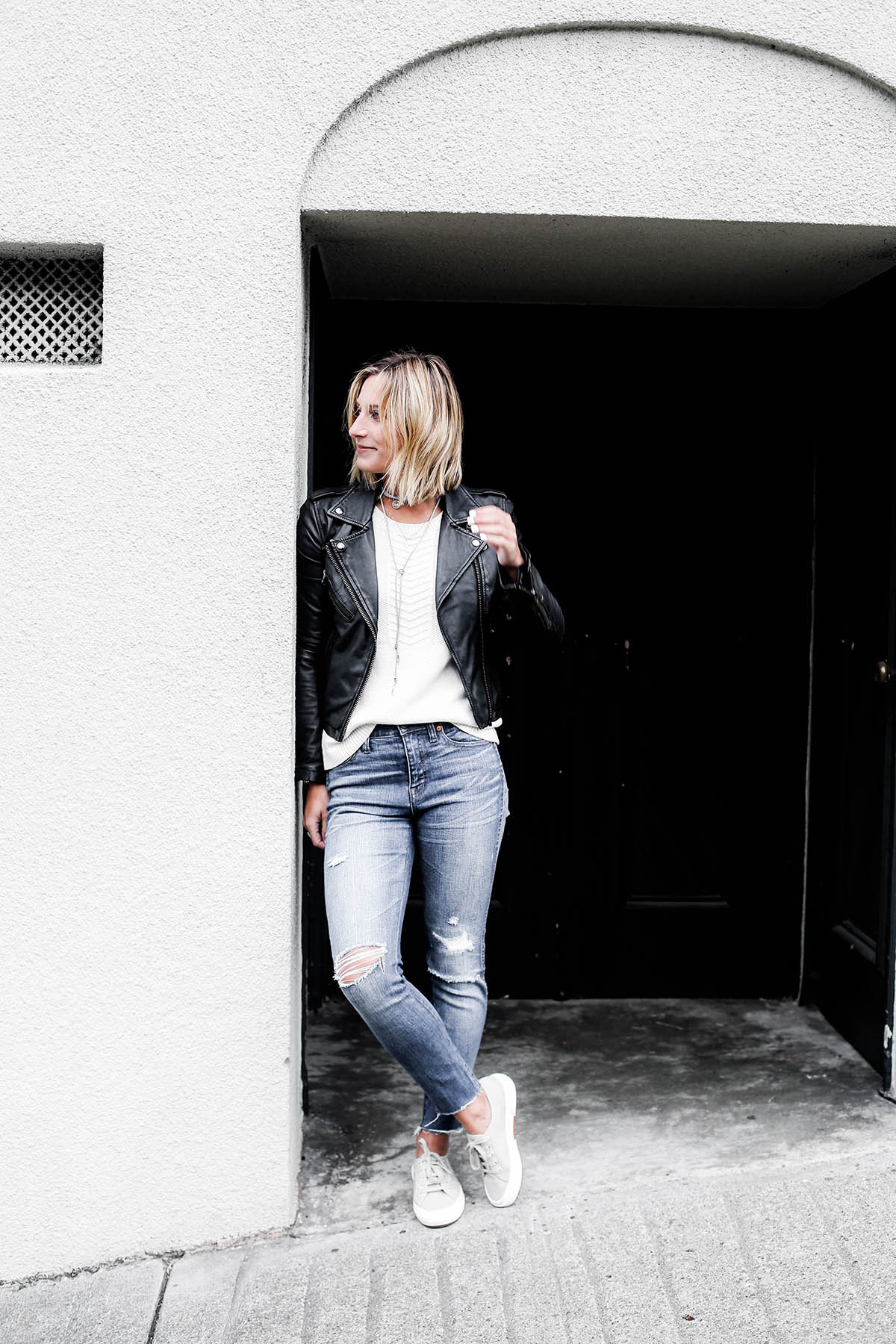 black leather moto jacket with madewell distressed skinny jeans and superga sneakers