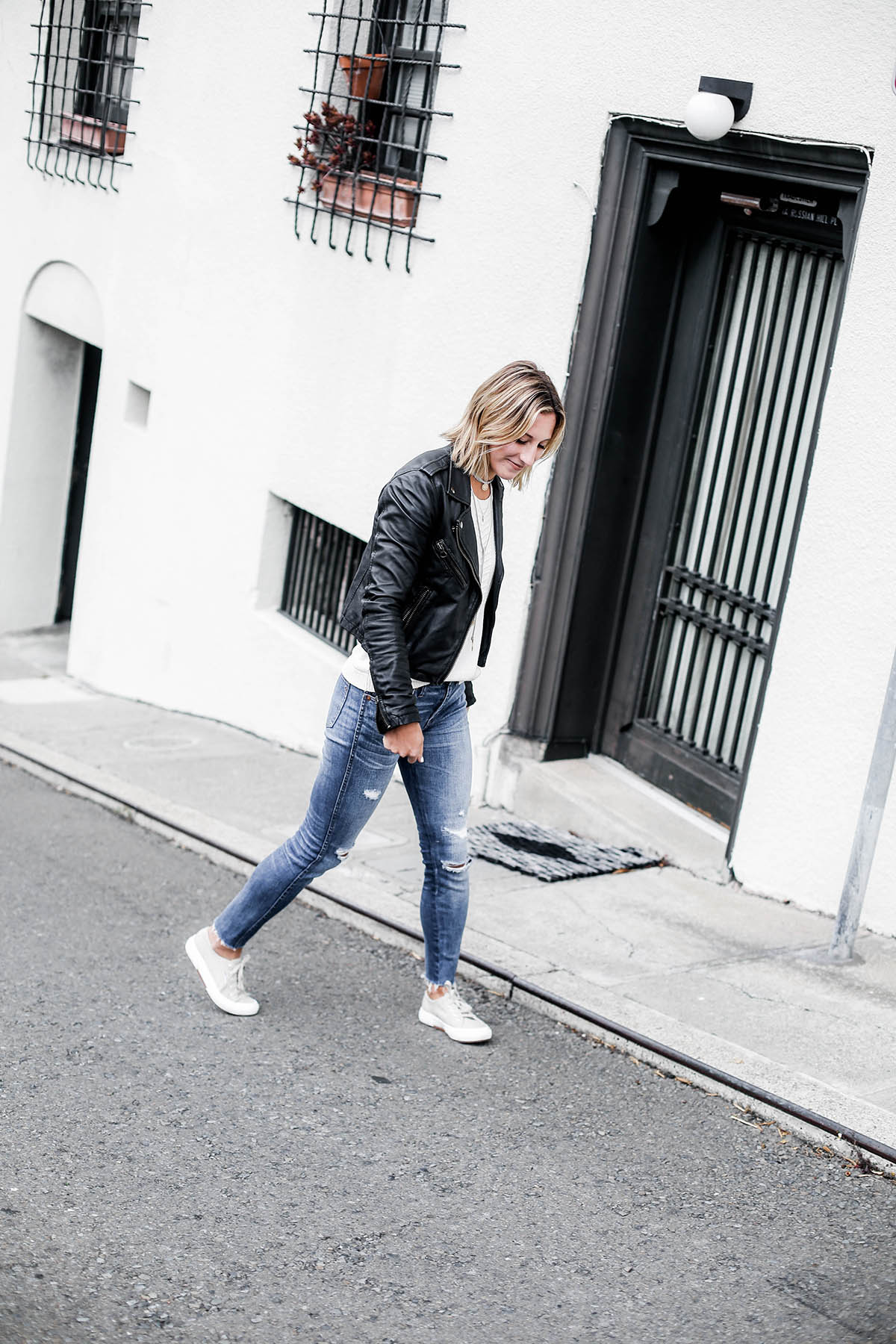 black leather moto jacket with madewell distressed skinny jeans and superga sneakers