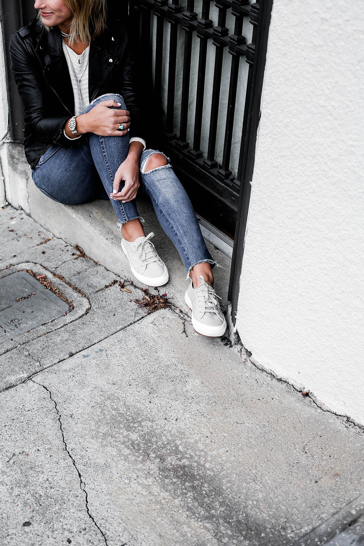 black leather moto jacket with madewell distressed skinny jeans and superga sneakers