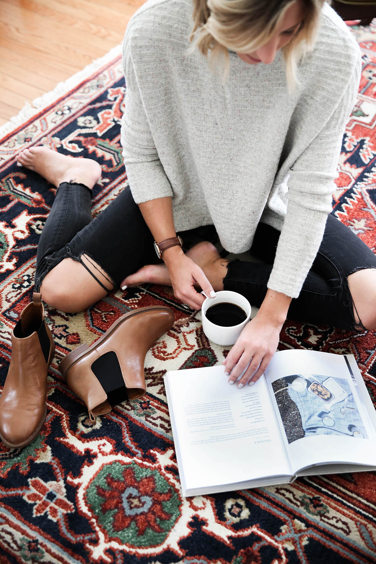 free people arctic fox sweater with chelsea boots and black distressed skinny jeans on antique rug