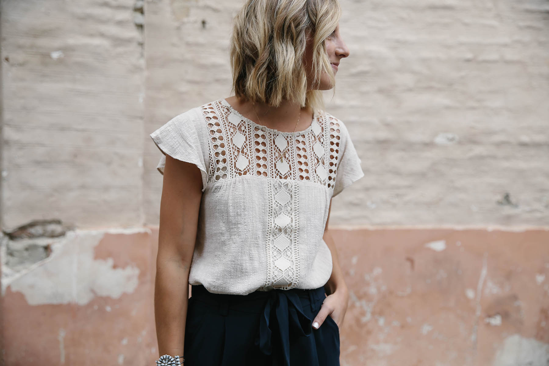 navy culottes outfit with crochet top and short blunt bob hairstyle