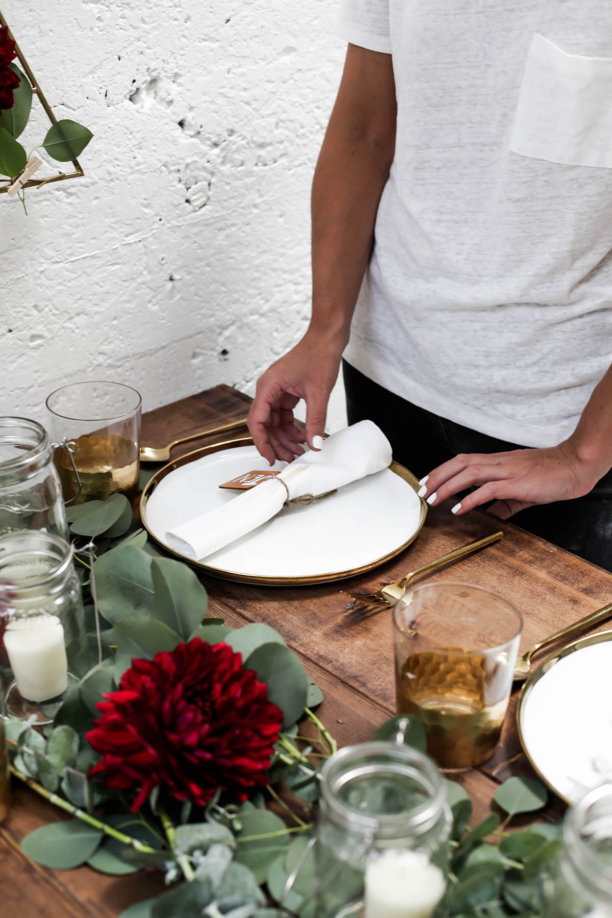 natural bohemian holiday tablescape with gold flatware, candles, mason jars, florals and eucalyptus