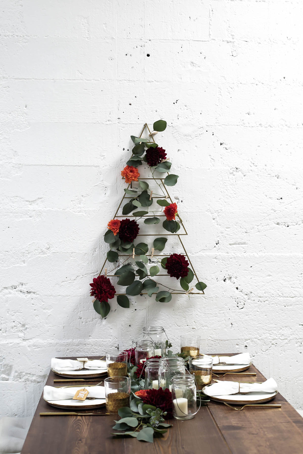 natural bohemian holiday tablescape with gold flatware, candles, mason jars, florals and eucalyptus