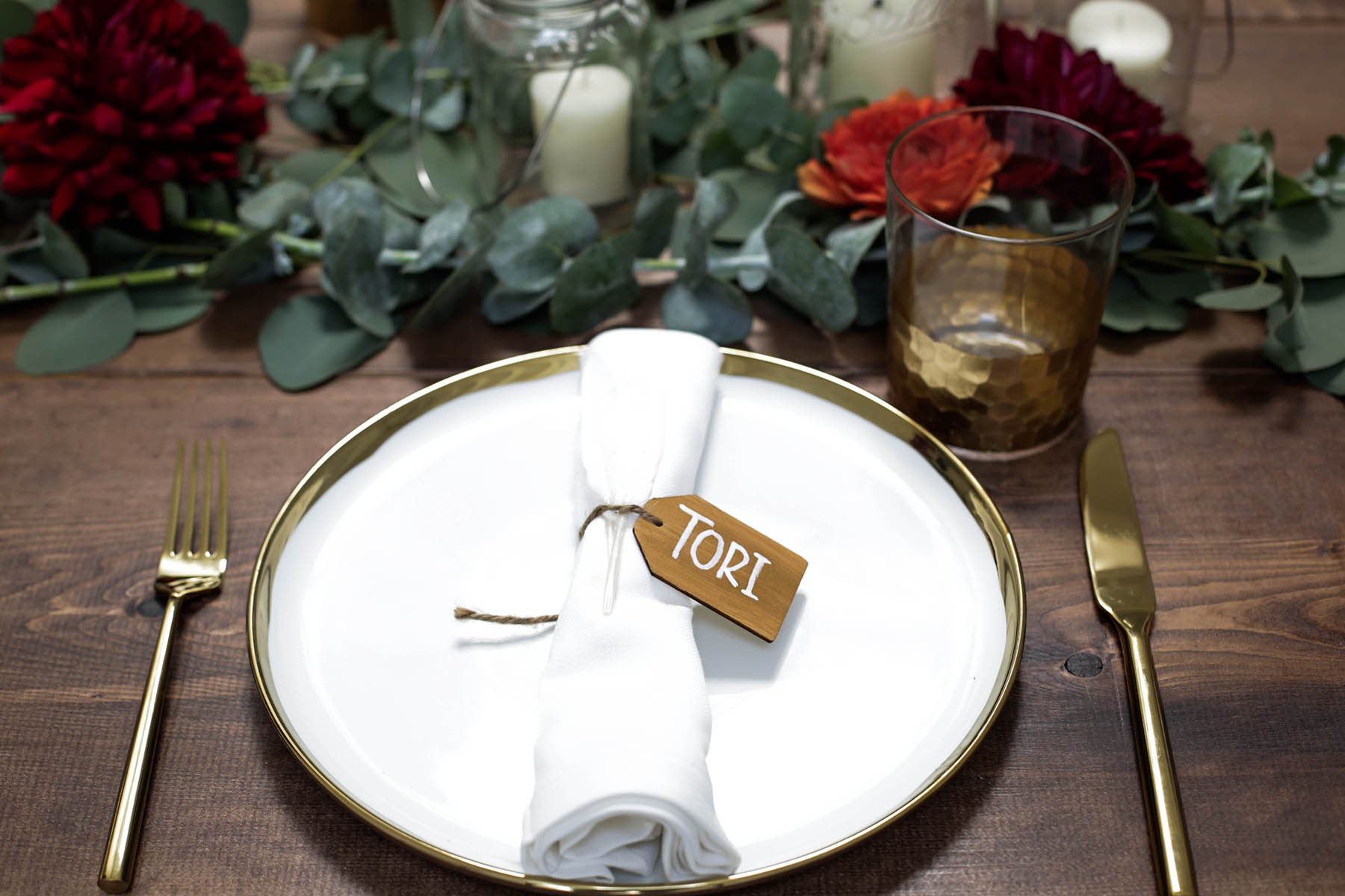 DIY name tags for natural bohemian holiday tablescape with gold flatware, candles, mason jars, florals and eucalyptus