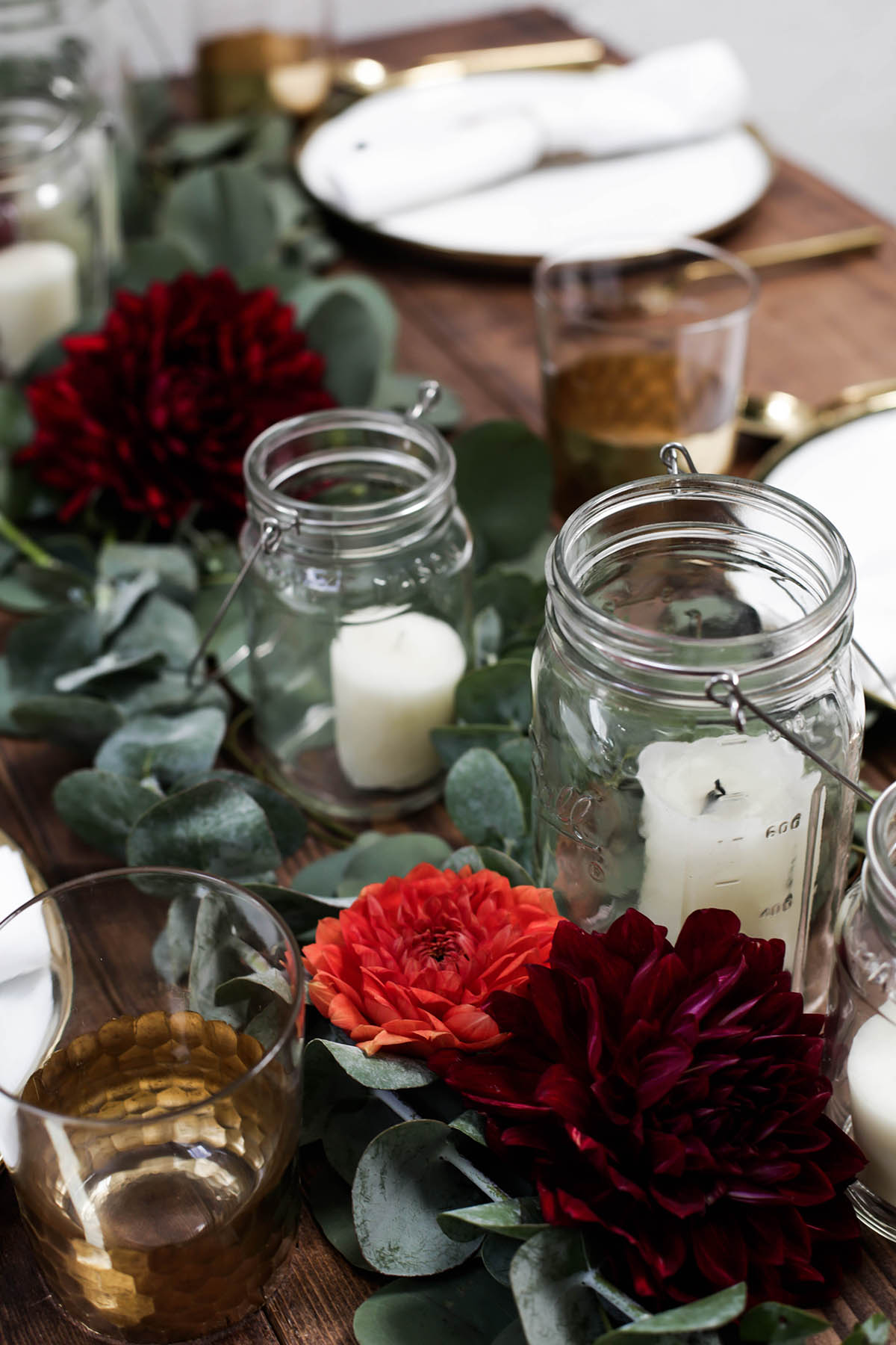 DIY holiday tablescape centerpiece candles mason jars eucalyptus and flowers