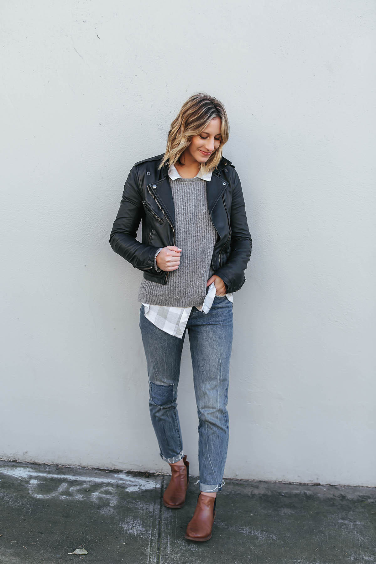 layered outfits with sweater and moto jacket