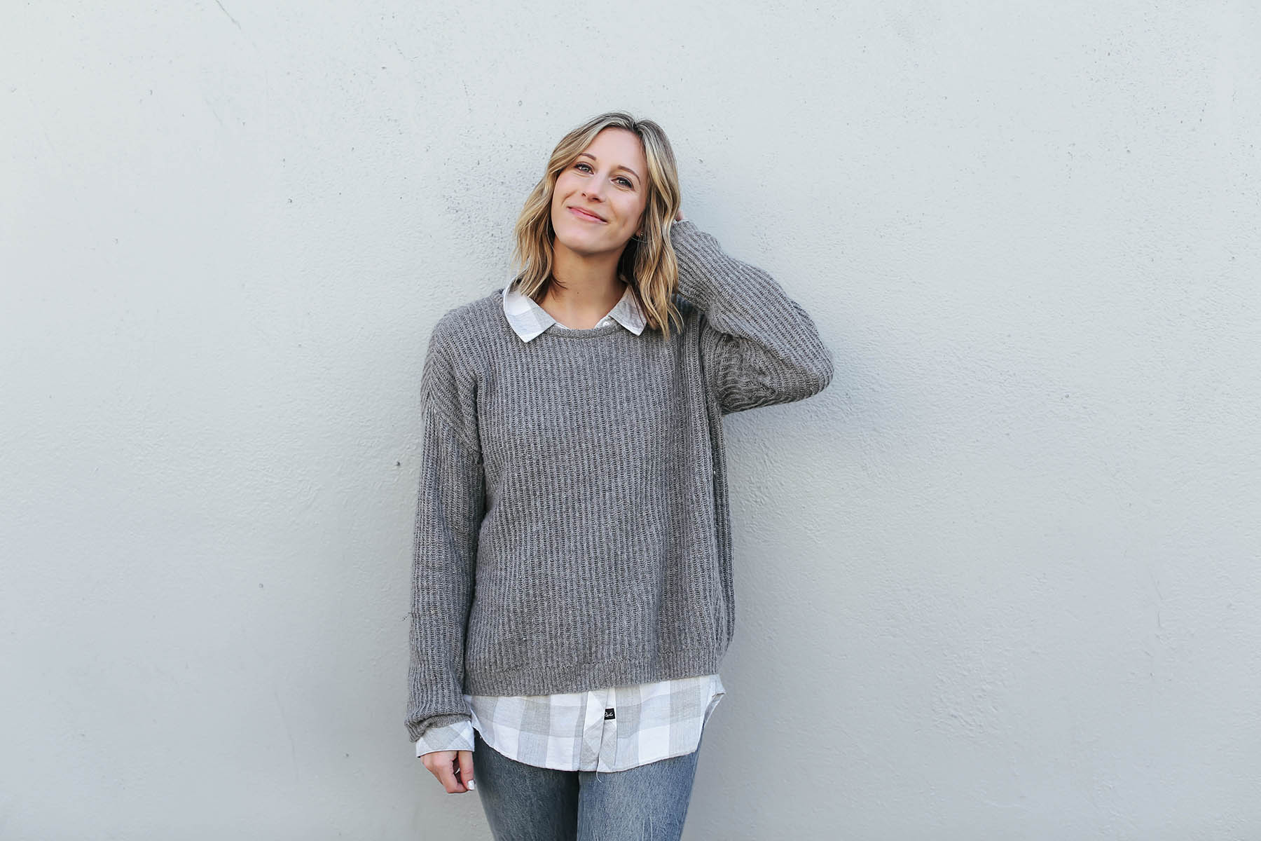 sweater layered over button-down shirt