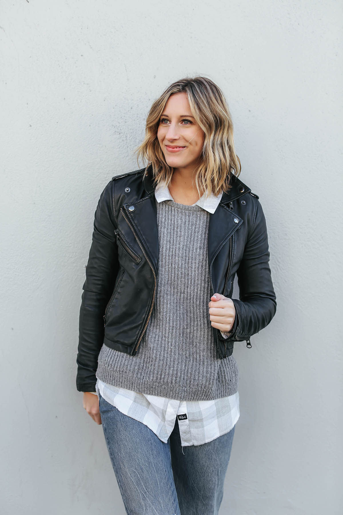 layered outfits with sweater and moto jacket