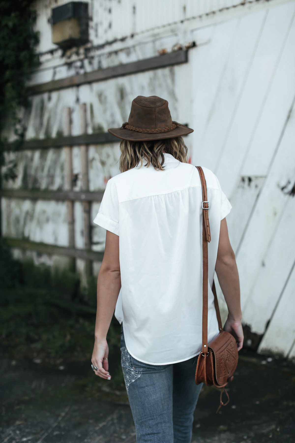 brown leather hat and white button-down