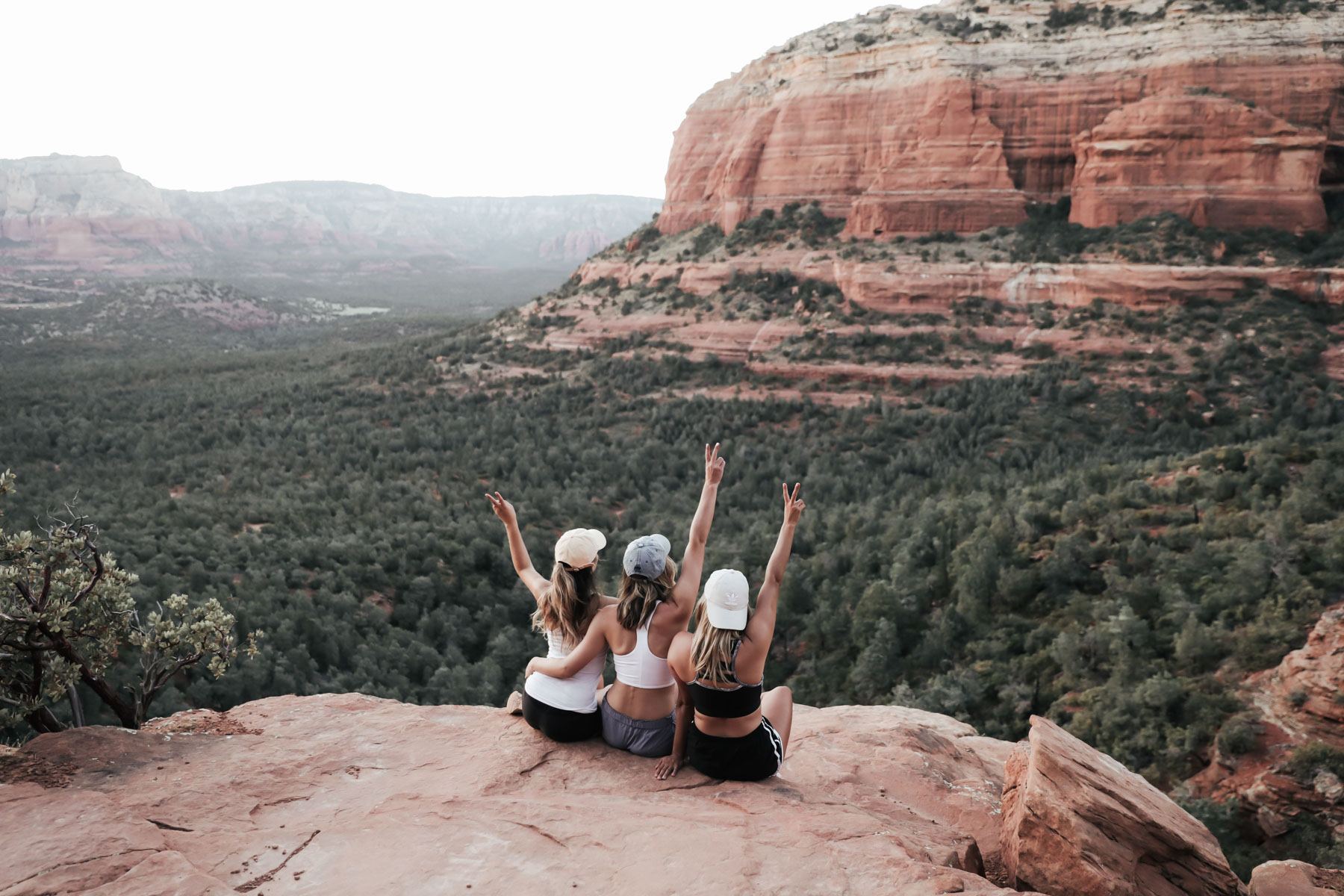 southwest road trip hiking Devli's Bridge with friends peace sign