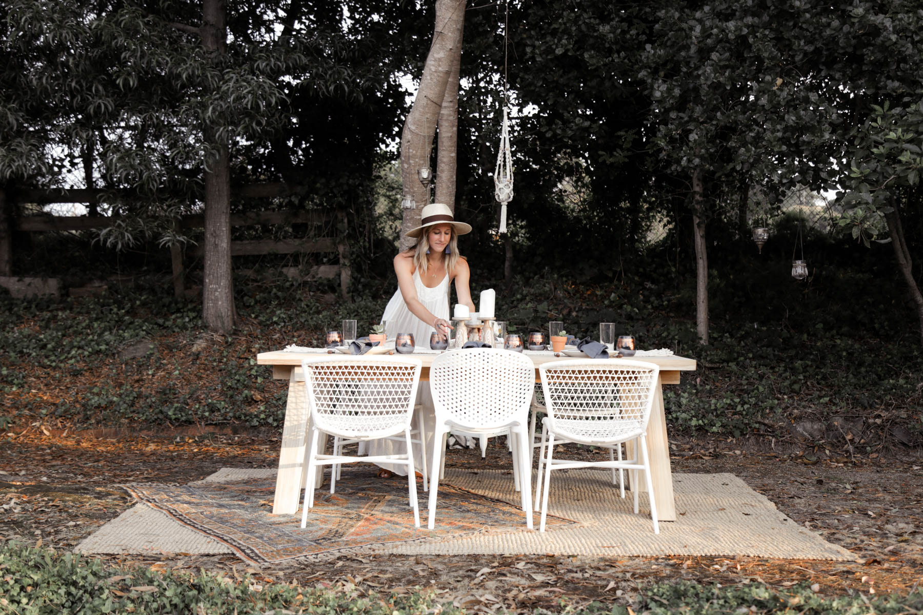 bohemian outdoor dining area with Article table and chairs and Urban Outfitters rug