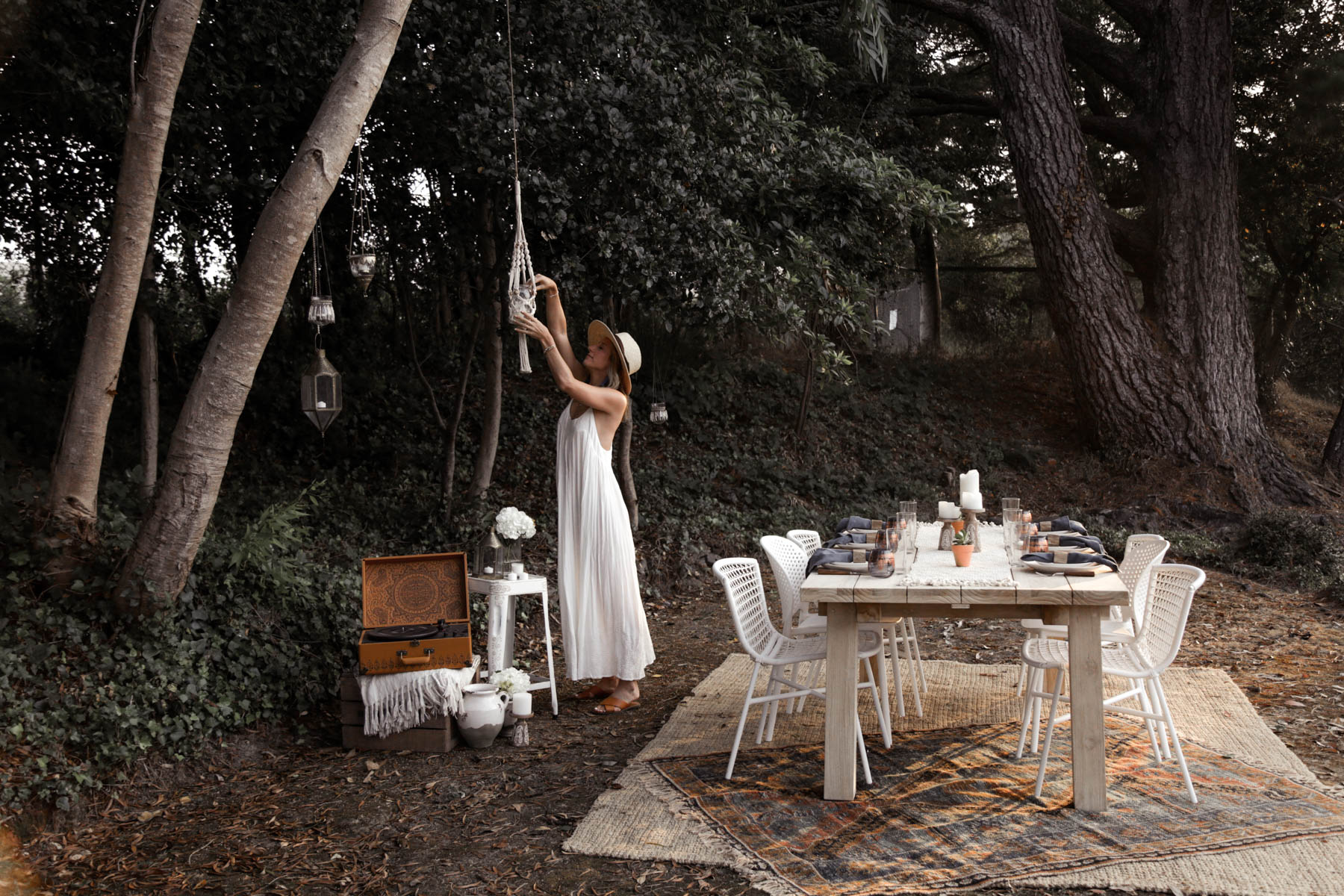 bohemian outdoor dining area with Article table and urban outfitters rug