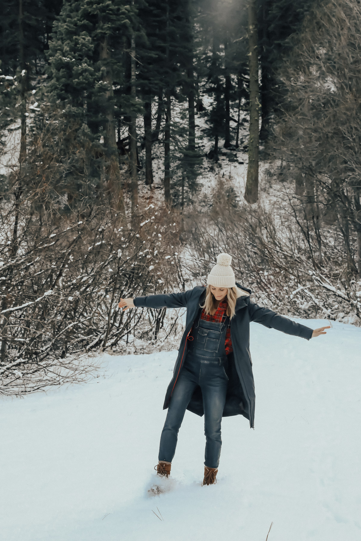 snow outfit with plaid shirt, overalls, and sorell boots