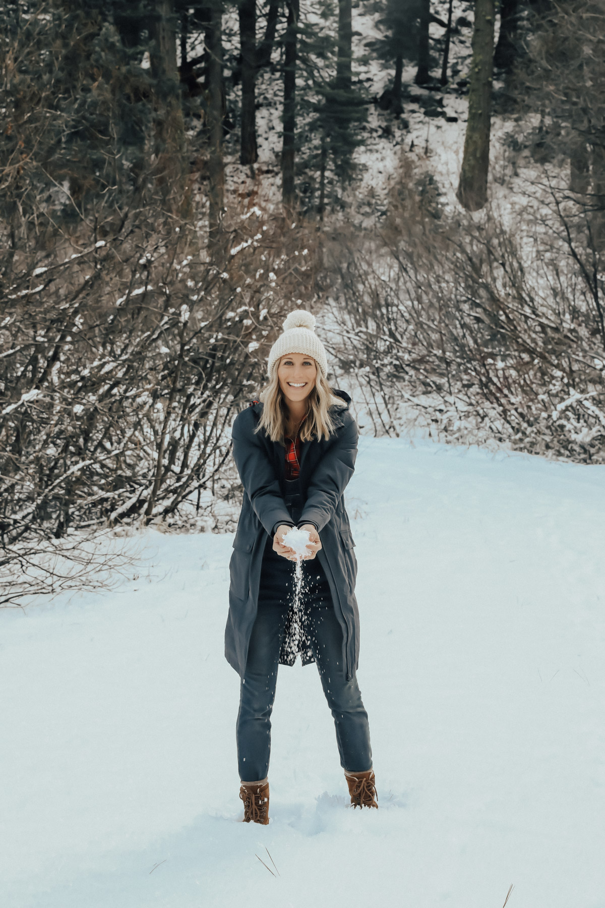 snow outfit with plaid shirt, overalls, and sorell boots