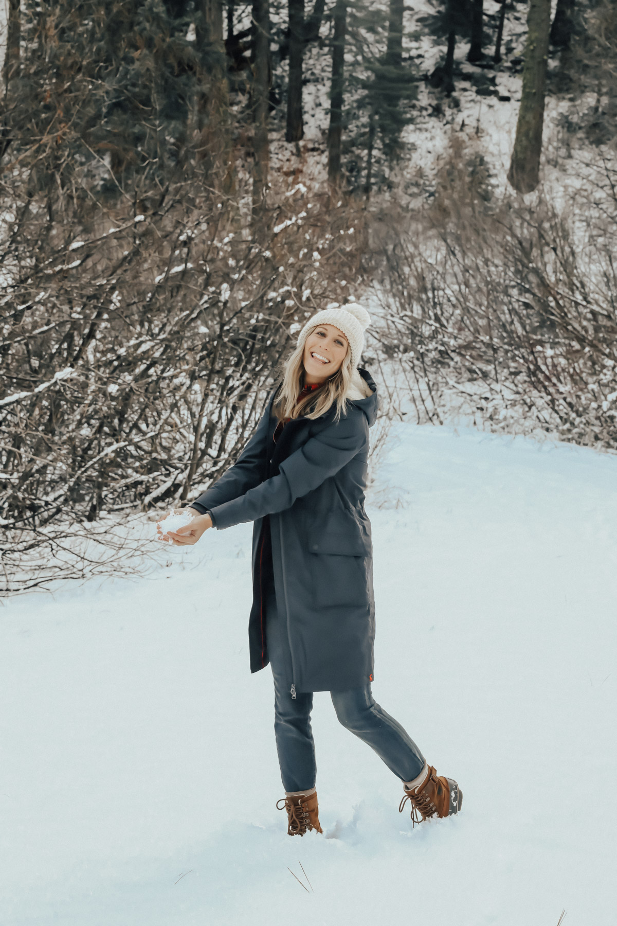 snow outfit with plaid shirt, overalls, and sorell boots