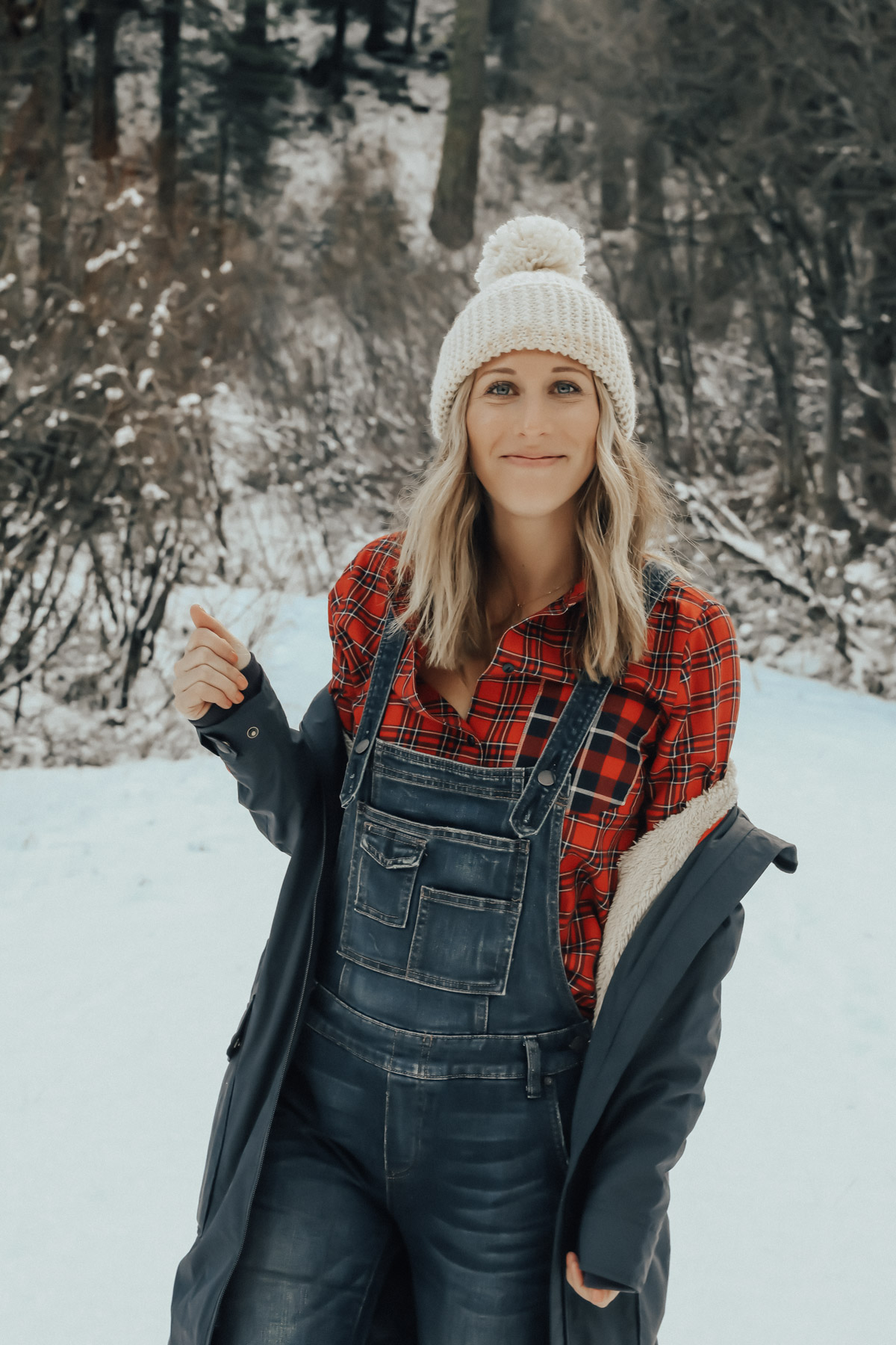 snow outfit with plaid shirt, overalls, and sorell boots