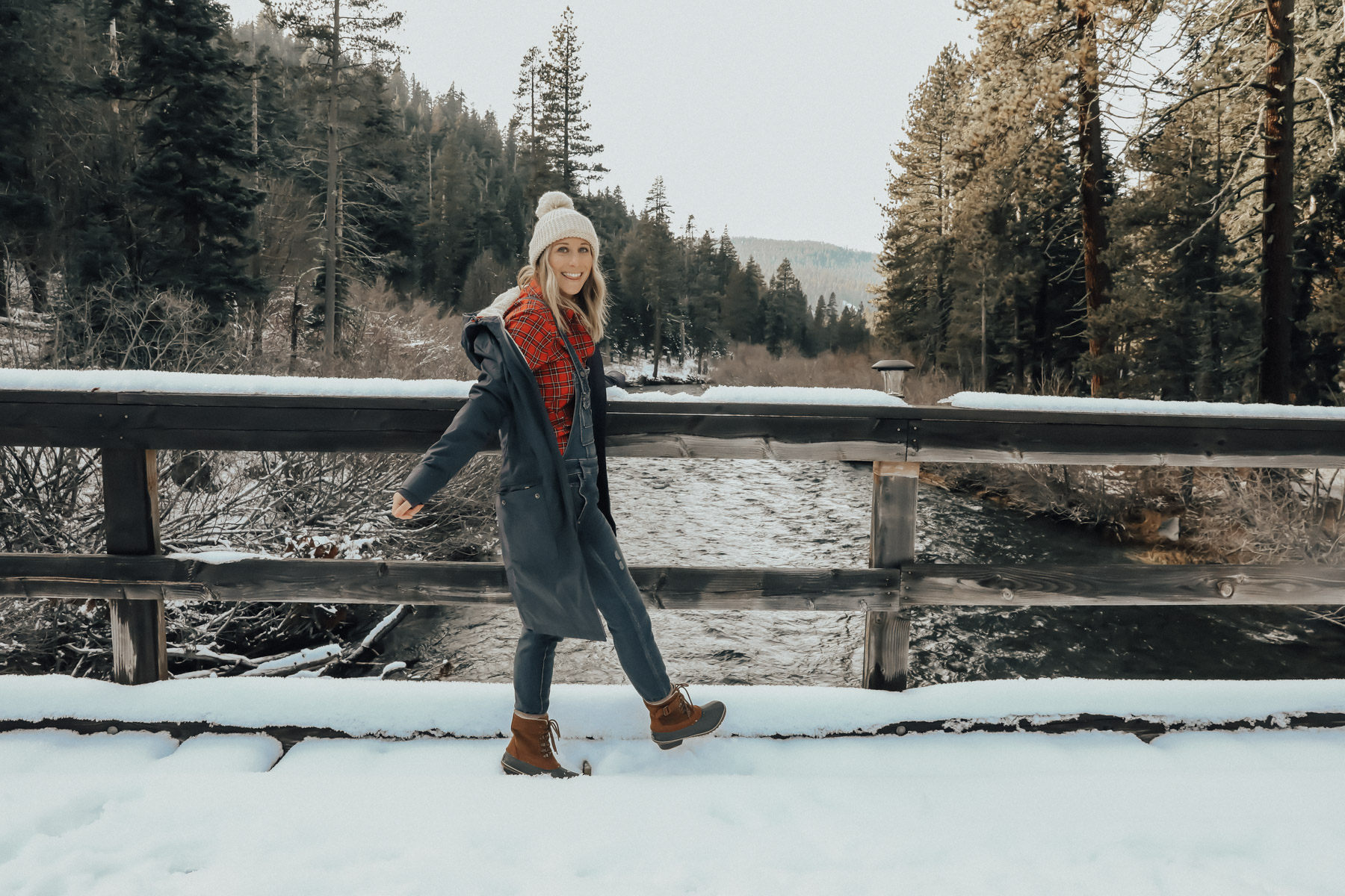 snow outfit with plaid shirt, overalls, and sorell boots